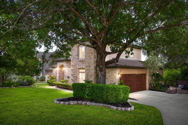 3 Stillmeadow Ct, The Hills, TX 78738 - view of property hidden behind natural elements featuring stone siding, concrete driveway, an attached garage, a front lawn, and stucco siding