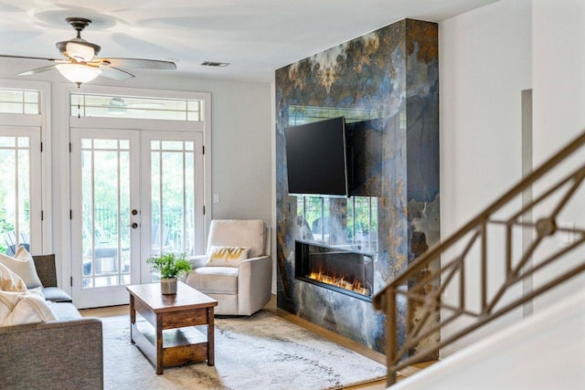 3 Stillmeadow Ct, The Hills, TX 78738 - living area featuring a large fireplace, healthy amount of natural light, french doors, and a ceiling fan