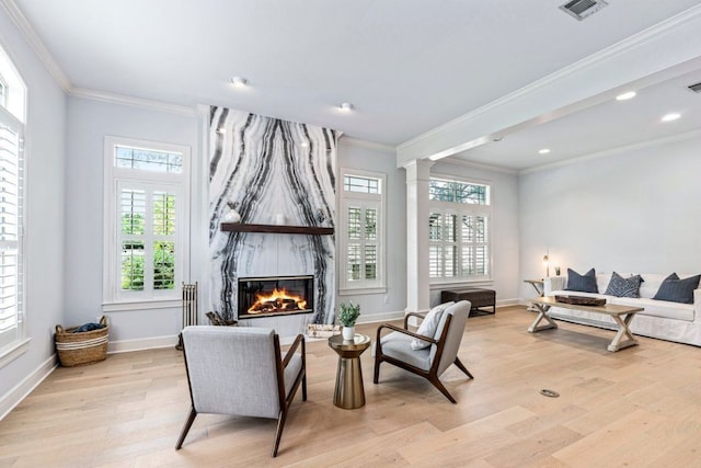3 Stillmeadow Ct, The Hills, TX 78738 - living area featuring light wood-style flooring, ornamental molding, a high end fireplace, ornate columns, and recessed lighting