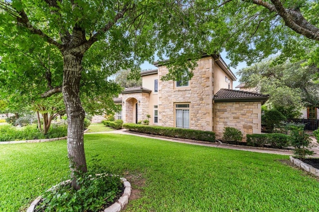 3 Stillmeadow Ct, The Hills, TX 78738 - mediterranean / spanish house with stone siding, a front lawn, and stucco siding