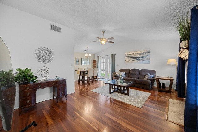 1111 Fairlawn Cv, Round Rock, TX 78664 - living area with wood finished floors, a ceiling fan, lofted ceiling, a textured ceiling, and french doors