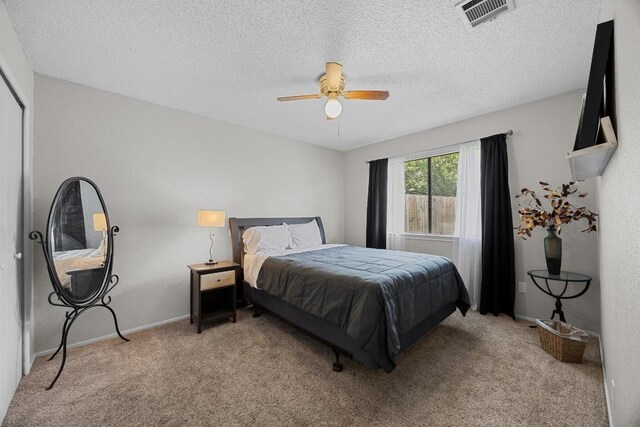 1111 Fairlawn Cv, Round Rock, TX 78664 - bedroom with light carpet, ceiling fan, and a textured ceiling