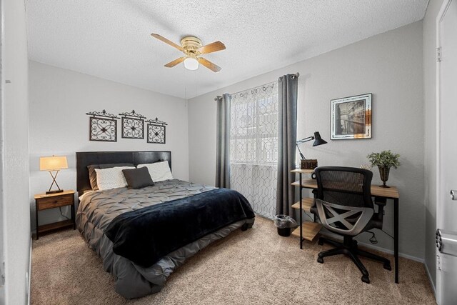 1111 Fairlawn Cv, Round Rock, TX 78664 - carpeted bedroom featuring a desk, a textured ceiling, and ceiling fan