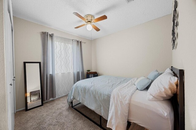 1111 Fairlawn Cv, Round Rock, TX 78664 - bedroom with carpet, a textured ceiling, and ceiling fan