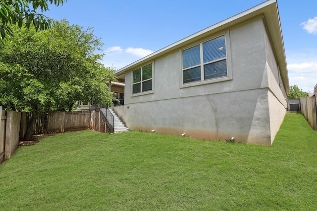 15617 Cinca Terra Dr, Bee Cave, TX 78738 - rear view of property featuring stairs, a fenced backyard, and stucco siding