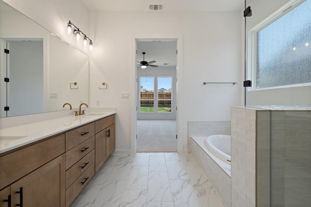 418 Darley Oak Dr, Dripping Springs, TX 78620 - bathroom with double vanity, a bath, ceiling fan, and marble finish floors