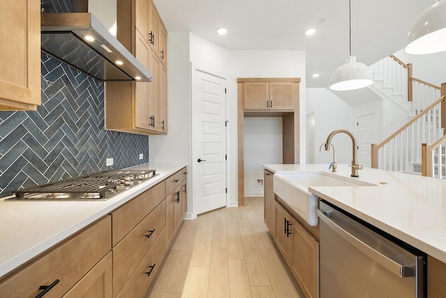 418 Darley Oak Dr, Dripping Springs, TX 78620 - kitchen with stainless steel appliances, wall chimney exhaust hood, backsplash, light countertops, and decorative light fixtures