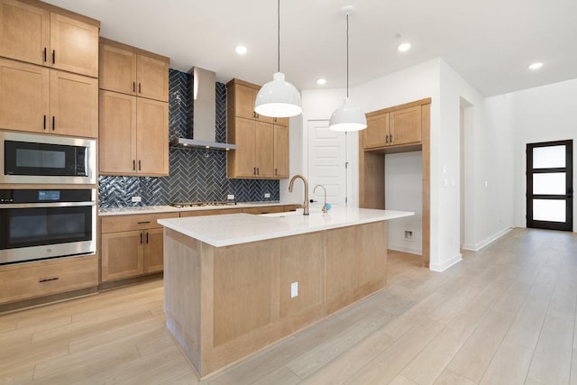 418 Darley Oak Dr, Dripping Springs, TX 78620 - kitchen featuring oven, wall chimney exhaust hood, built in microwave, backsplash, and light wood finished floors