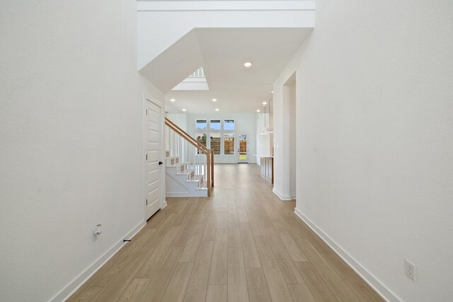 418 Darley Oak Dr, Dripping Springs, TX 78620 - hallway featuring stairs, light wood-type flooring, and recessed lighting