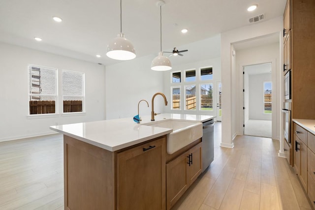 418 Darley Oak Dr, Dripping Springs, TX 78620 - kitchen featuring light wood-type flooring, stainless steel appliances, recessed lighting, light countertops, and a center island with sink