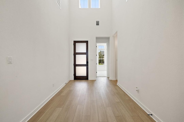 418 Darley Oak Dr, Dripping Springs, TX 78620 - foyer with healthy amount of natural light, light wood-style flooring, and a towering ceiling