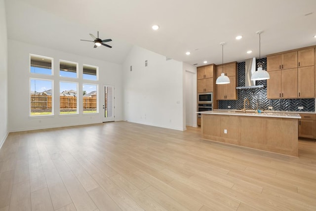 418 Darley Oak Dr, Dripping Springs, TX 78620 - kitchen with appliances with stainless steel finishes, wall chimney range hood, open floor plan, ceiling fan, and recessed lighting