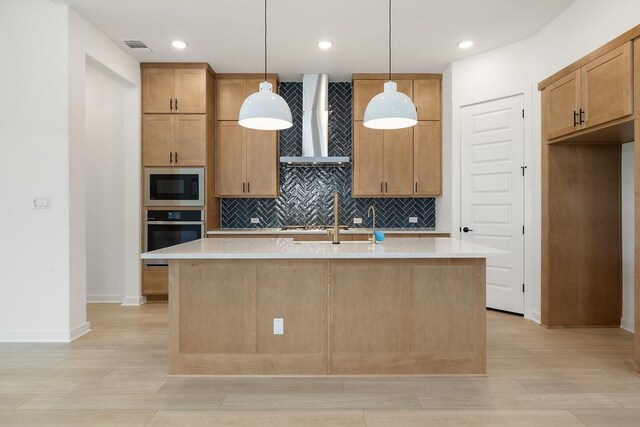 418 Darley Oak Dr, Dripping Springs, TX 78620 - kitchen featuring wall chimney exhaust hood, built in microwave, stainless steel oven, a kitchen island with sink, and light countertops