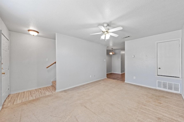 204 Meadowview Ln, Gatesville, TX 76528 - carpeted empty room with ceiling fan, a textured ceiling, and stairway