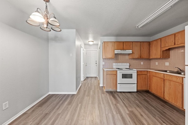 204 Meadowview Ln, Gatesville, TX 76528 - kitchen with white range with electric cooktop, under cabinet range hood, wood finished floors, light countertops, and a textured ceiling