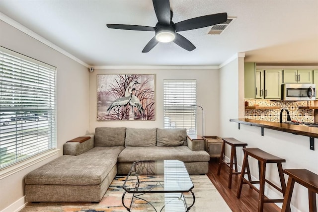 17729 Golden Valley Dr, Manor, TX 78653 - living area with wood finished floors, crown molding, and ceiling fan