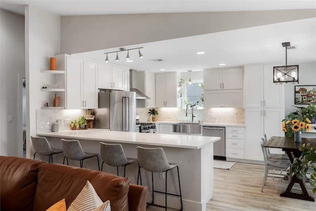 7619 Scenic Brook Dr, Austin, TX 78736 - kitchen with stainless steel appliances, open shelves, a peninsula, white cabinets, and light countertops