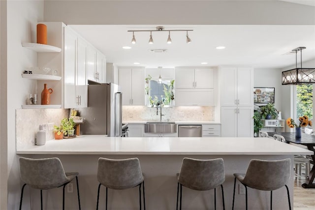 7619 Scenic Brook Dr, Austin, TX 78736 - kitchen featuring open shelves, appliances with stainless steel finishes, light countertops, and white cabinetry