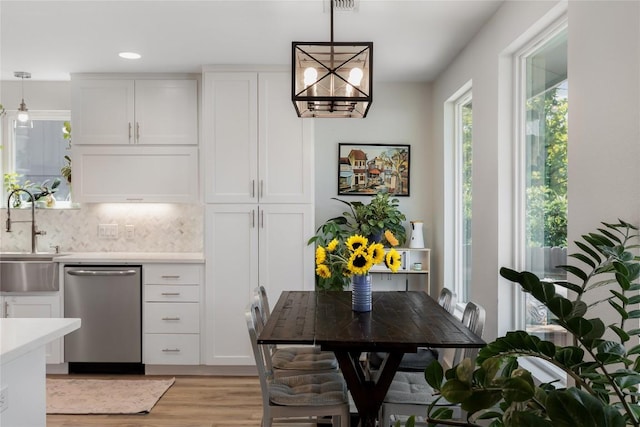 7619 Scenic Brook Dr, Austin, TX 78736 - kitchen featuring dishwasher, white cabinetry, light countertops, light wood-style floors, and tasteful backsplash
