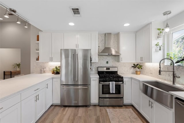 7619 Scenic Brook Dr, Austin, TX 78736 - kitchen featuring appliances with stainless steel finishes, wall chimney range hood, open shelves, light countertops, and white cabinetry