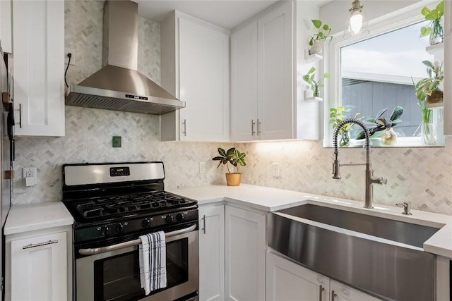 7619 Scenic Brook Dr, Austin, TX 78736 - kitchen with wall chimney exhaust hood, stainless steel gas range, white cabinetry, and light countertops