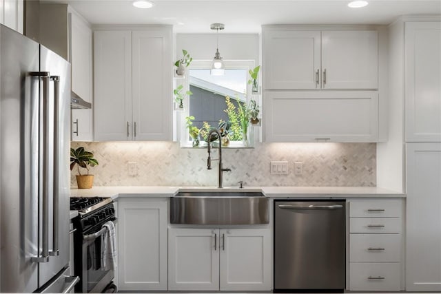 7619 Scenic Brook Dr, Austin, TX 78736 - kitchen featuring stainless steel appliances, light countertops, backsplash, recessed lighting, and decorative light fixtures