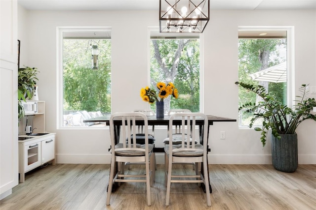 7619 Scenic Brook Dr, Austin, TX 78736 - dining area with light wood finished floors, a chandelier, and healthy amount of natural light