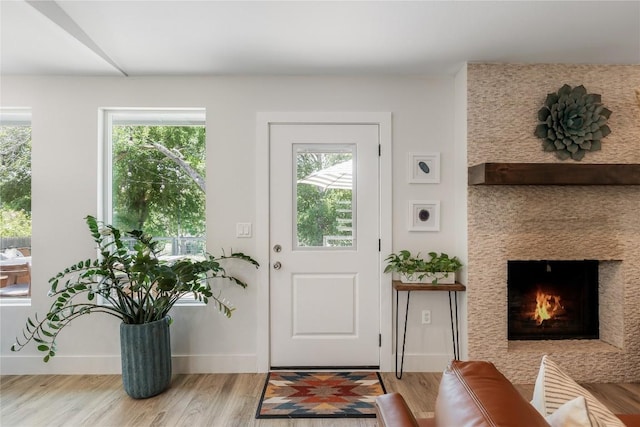 7619 Scenic Brook Dr, Austin, TX 78736 - doorway to outside with light wood-style flooring, plenty of natural light, and a fireplace with flush hearth