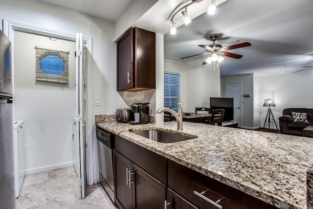 501 W 26th St Unit 105, Austin, TX 78705 - kitchen featuring washer and dryer, a ceiling fan, stainless steel dishwasher, light stone counters, and dark brown cabinetry
