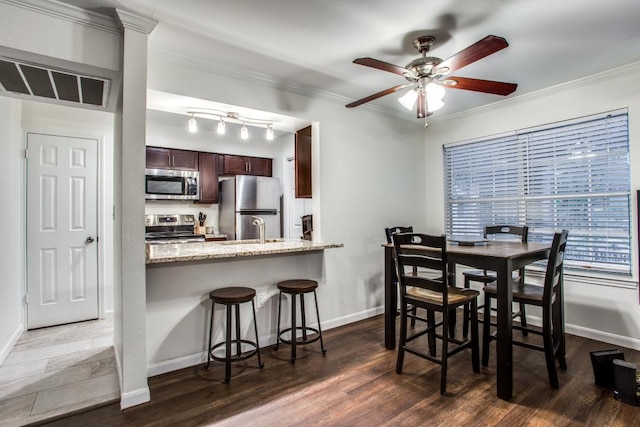 501 W 26th St Unit 105, Austin, TX 78705 - dining space with a ceiling fan, dark wood-type flooring, and ornamental molding