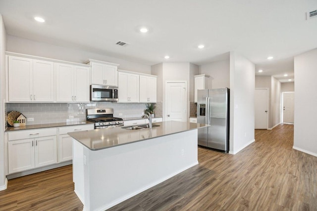 1524 Brueggerhoff Rd, Leander, TX 78641 - kitchen with stainless steel appliances, dark wood finished floors, decorative backsplash, and recessed lighting