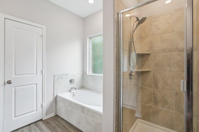 1524 Brueggerhoff Rd, Leander, TX 78641 - bathroom with a bath, a shower stall, and wood finished floors