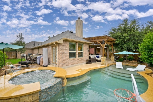 169 Fort Cobb Way, Georgetown, TX 78628 - view of swimming pool with a pergola, a patio, an outdoor living space with a fire pit, and a pool with connected hot tub