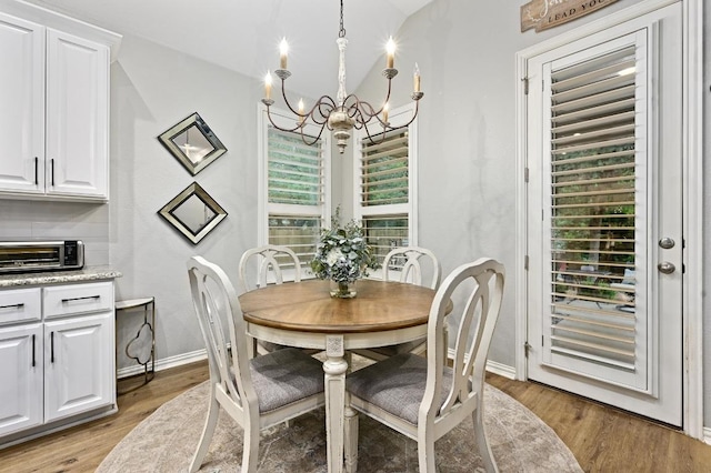 169 Fort Cobb Way, Georgetown, TX 78628 - dining space featuring a chandelier and light wood-style floors