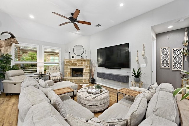 169 Fort Cobb Way, Georgetown, TX 78628 - living area with ceiling fan, wood finished floors, vaulted ceiling, recessed lighting, and a stone fireplace