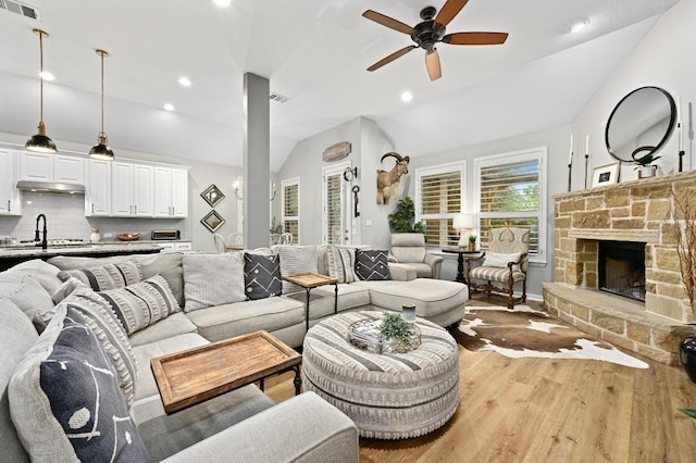 169 Fort Cobb Way, Georgetown, TX 78628 - living area featuring lofted ceiling, ceiling fan, wood finished floors, a fireplace, and recessed lighting
