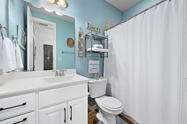 169 Fort Cobb Way, Georgetown, TX 78628 - full bathroom with a textured wall, vanity, wood finished floors, and a shower with curtain