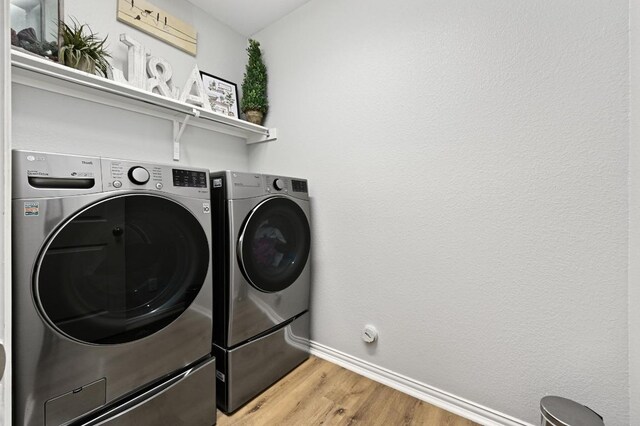 169 Fort Cobb Way, Georgetown, TX 78628 - laundry area with independent washer and dryer and light wood-style flooring