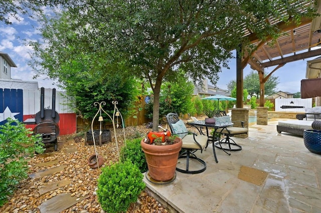 169 Fort Cobb Way, Georgetown, TX 78628 - fenced backyard with a pergola, a patio, and outdoor dining area