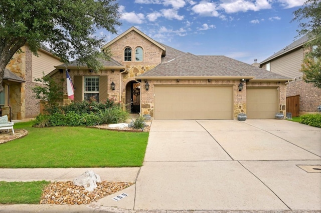 169 Fort Cobb Way, Georgetown, TX 78628 - french country home with brick siding, a garage, driveway, and a front yard