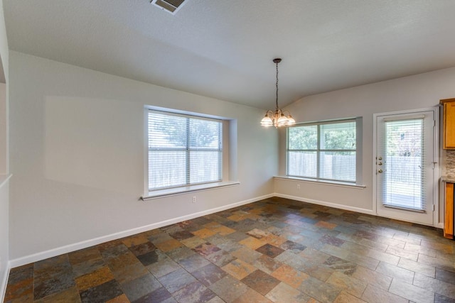 15737 Cadoz Dr, Austin, TX 78728 - unfurnished room featuring dark stone finish floors, a chandelier, plenty of natural light, and vaulted ceiling