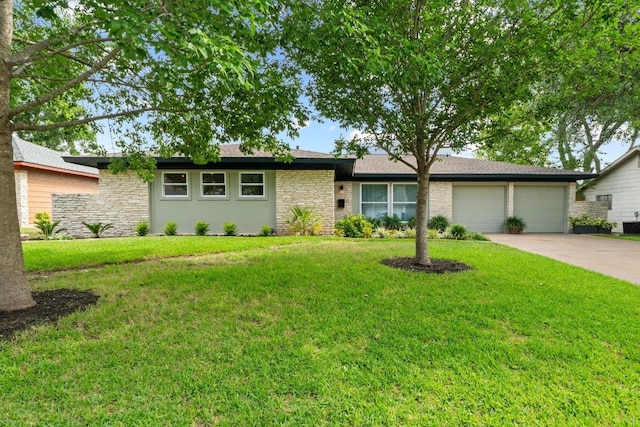 1909 Belford Dr, Austin, TX 78757 - single story home with stone siding, a garage, driveway, and a front lawn