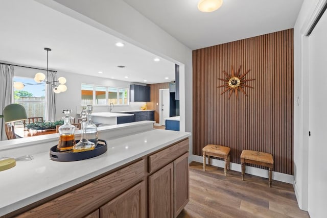 1909 Belford Dr, Austin, TX 78757 - kitchen with light wood finished floors, light countertops, an accent wall, plenty of natural light, and recessed lighting