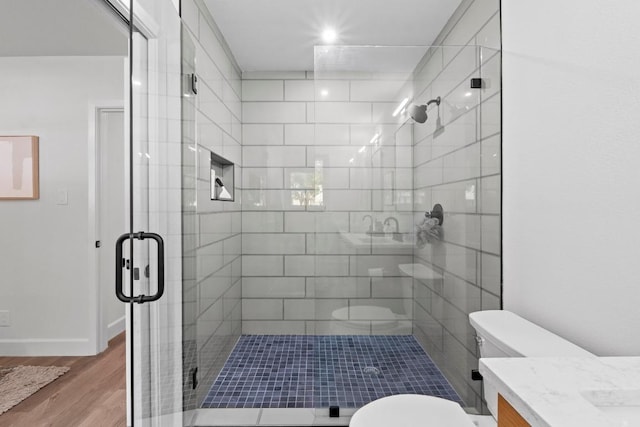 1909 Belford Dr, Austin, TX 78757 - bathroom featuring vanity, a stall shower, and wood finished floors