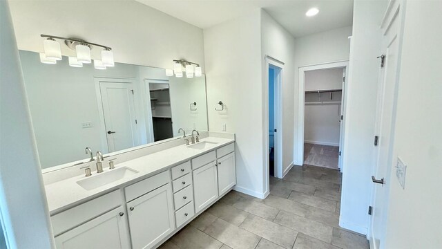 6800 Menchaca Rd Unit 31, Austin, TX 78745 - full bath featuring double vanity, a walk in closet, tile patterned flooring, and recessed lighting