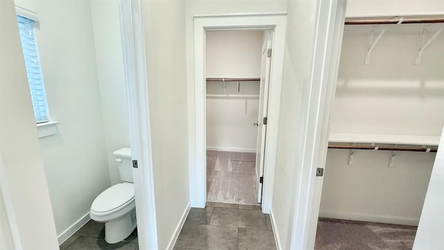 6800 Menchaca Rd Unit 31, Austin, TX 78745 - bathroom featuring a spacious closet, healthy amount of natural light, and tile patterned floors