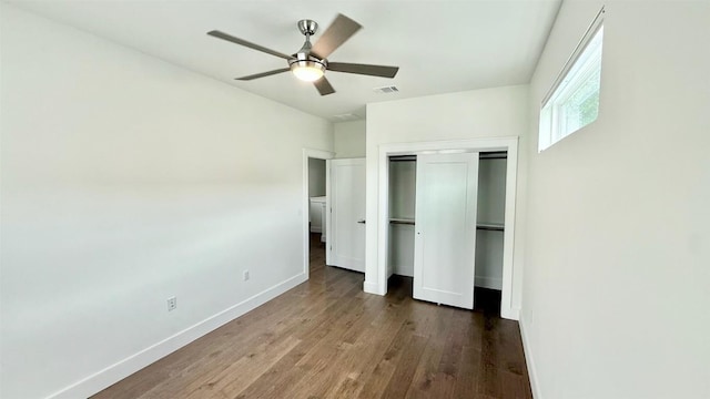 6800 Menchaca Rd Unit 31, Austin, TX 78745 - unfurnished bedroom with wood finished floors, a closet, and a ceiling fan