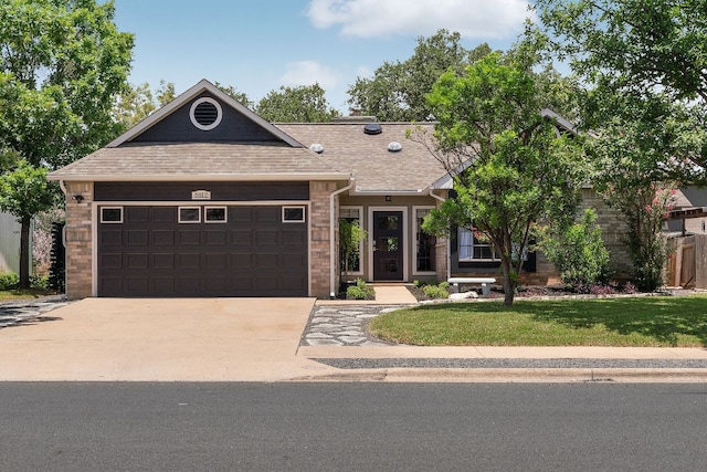 5812 Abilene Trl, Austin, TX 78749 - view of front of property with a garage, concrete driveway, a front lawn, and a shingled roof