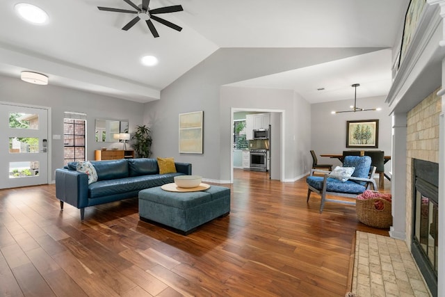 5812 Abilene Trl, Austin, TX 78749 - living room with vaulted ceiling, dark wood-style flooring, a ceiling fan, and a glass covered fireplace