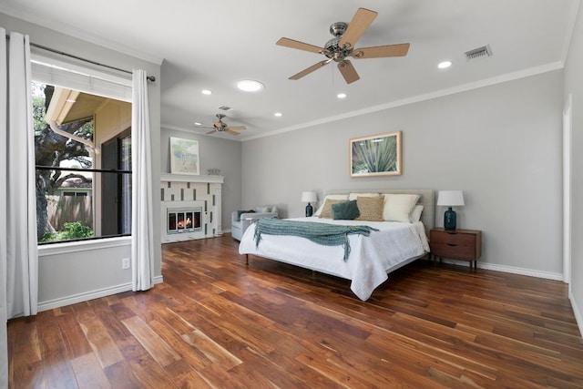 5812 Abilene Trl, Austin, TX 78749 - bedroom with multiple windows, wood finished floors, crown molding, recessed lighting, and a glass covered fireplace